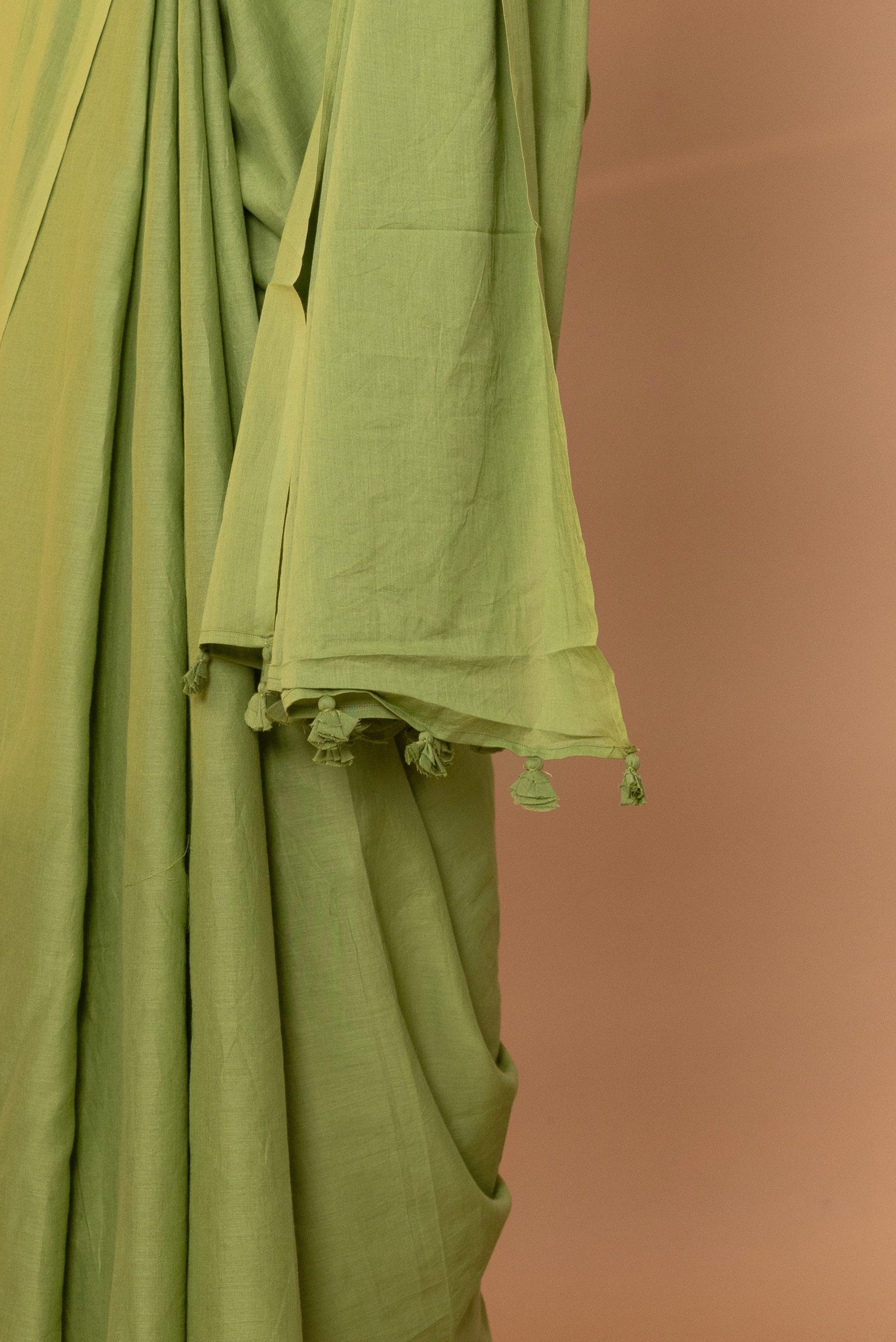 Avocado Green Plain Dyed Mul Mul Cotton Saree with Tassels (without Blouse)